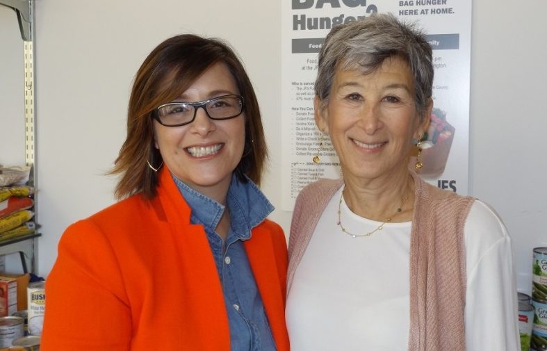 Basha Silverman and Dory Zatuchni stand together in front of the JFS food pantry.